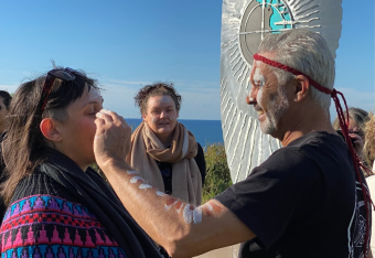 Indigenous elder applying face paint during welcome to country at Oak FlatsOak 